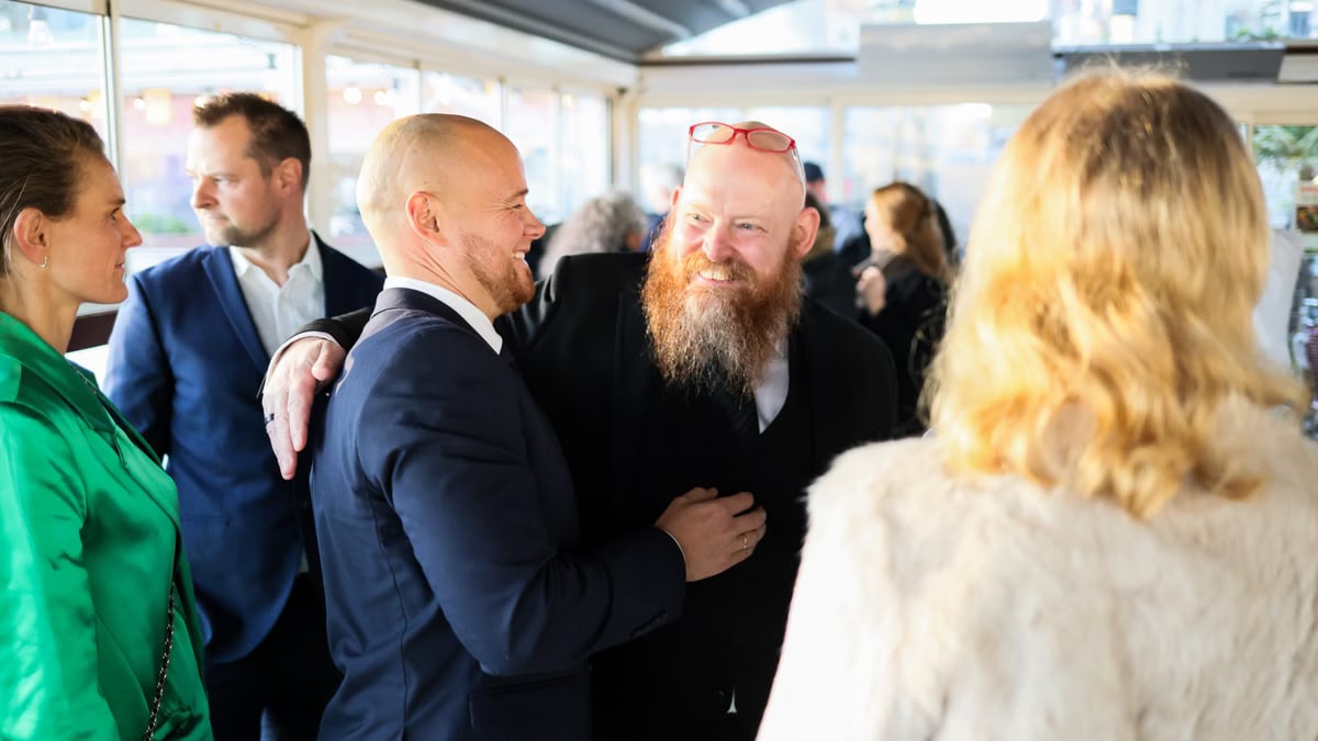 Candid scene of business professionals enjoying a jovial moment together indoors.
